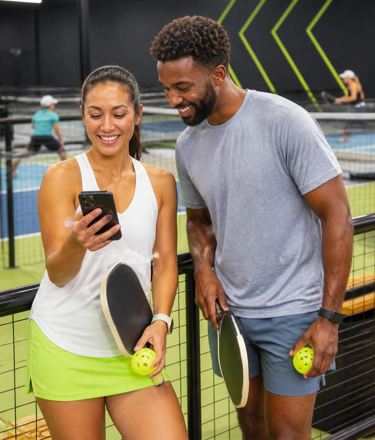 Pickleball players checking in on a phone at the courts